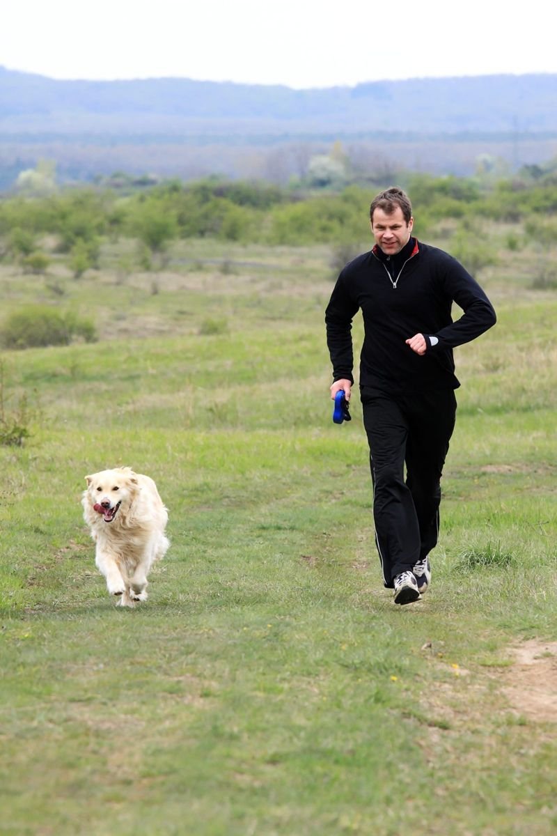 A young man running with your dog - How to Give Your Dog a Pill