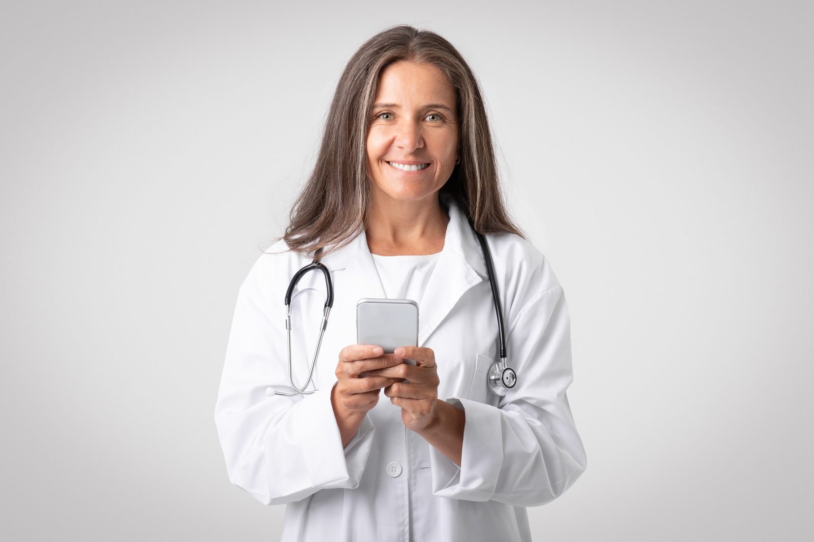 Woman doctor with stethoscope using smartphone – online vet doctor